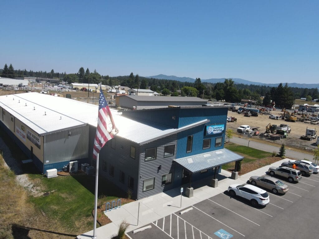 Aerial view of a gray and white steel structure building