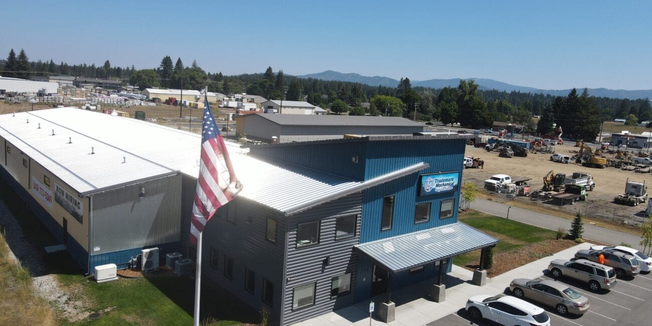 Aerial view of a gray and white steel structure building