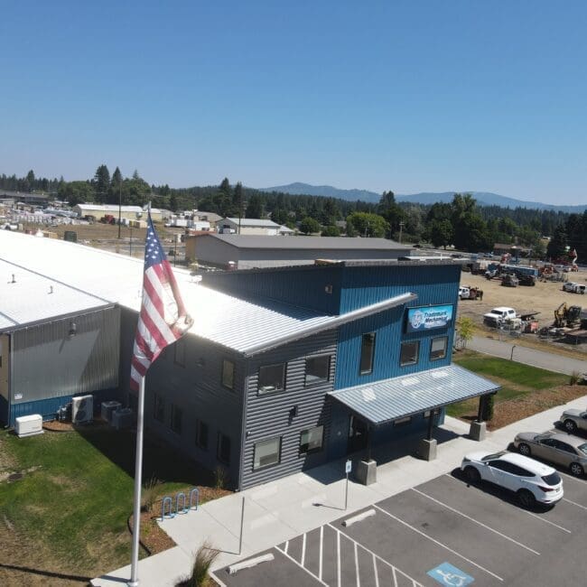 Aerial view of a gray and white steel structure building