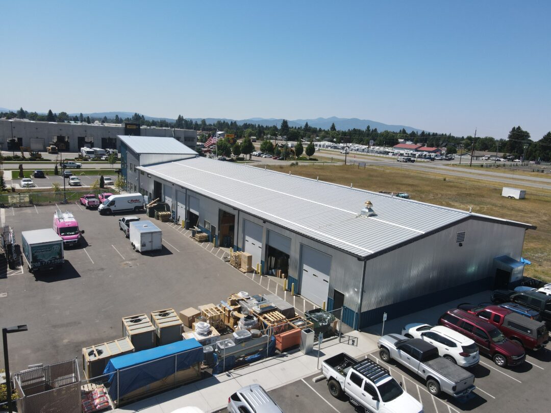 aerial view of the grey mechanical shop: steel structure with overhead white doors and gray roof
