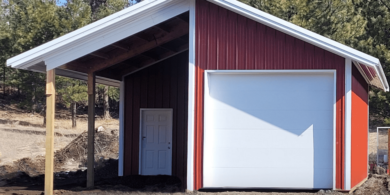red steel structure pole barn with white trim and white overhang garage door