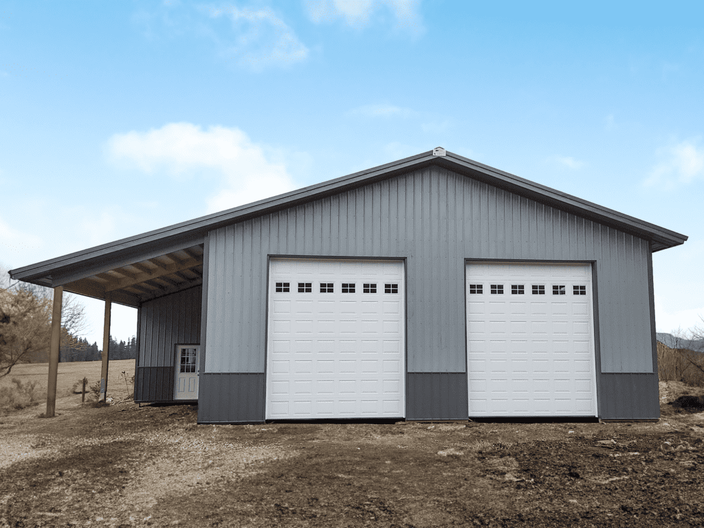 Gray steel structure garage shop with 2 white overhead garage doors