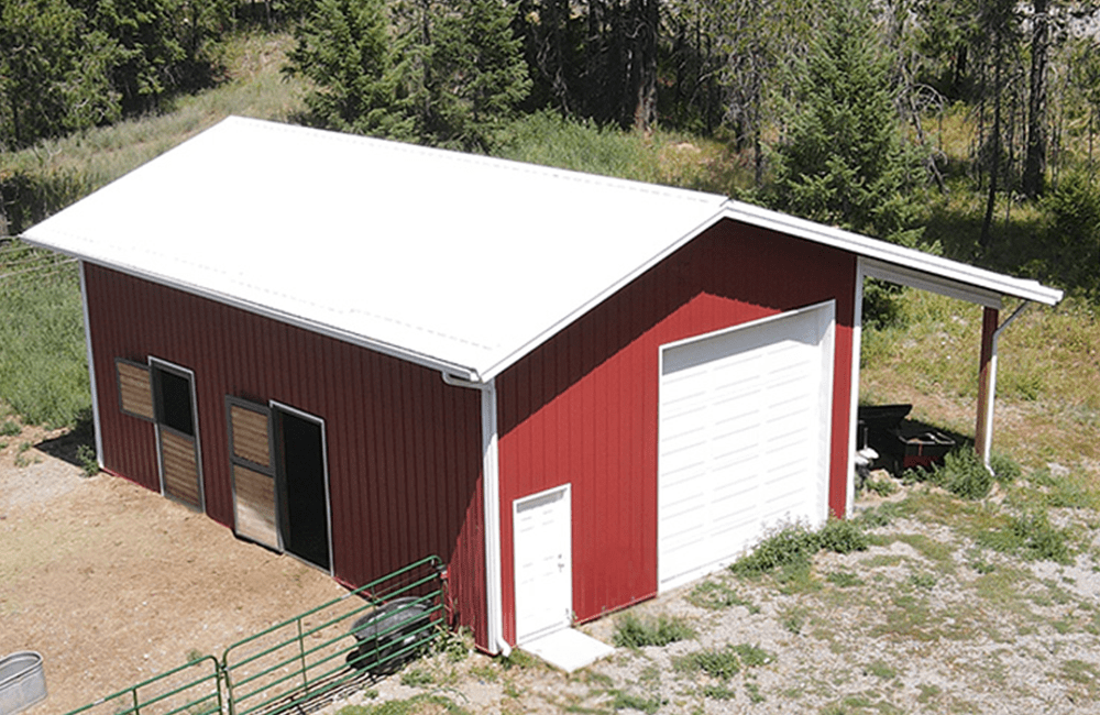 aerial view of a red horse barn with white overhead garage door