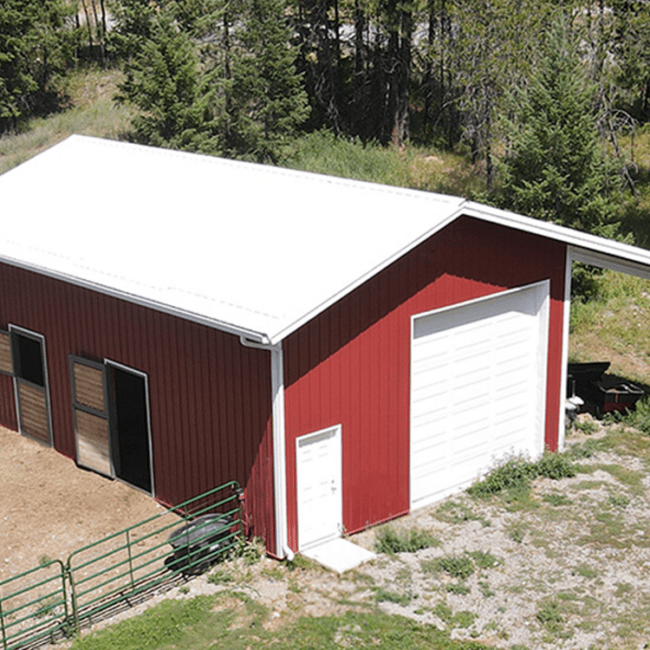 aerial view of a red horse barn with white overhead garage door