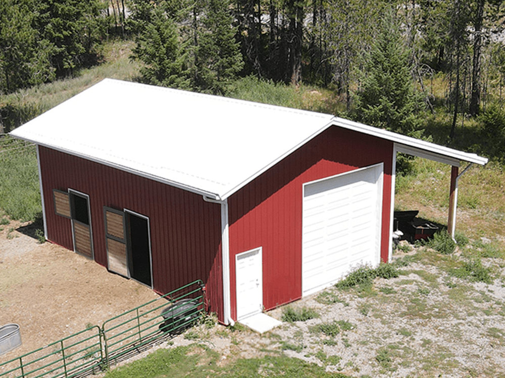 aerial view of a red horse barn with white overhead garage door