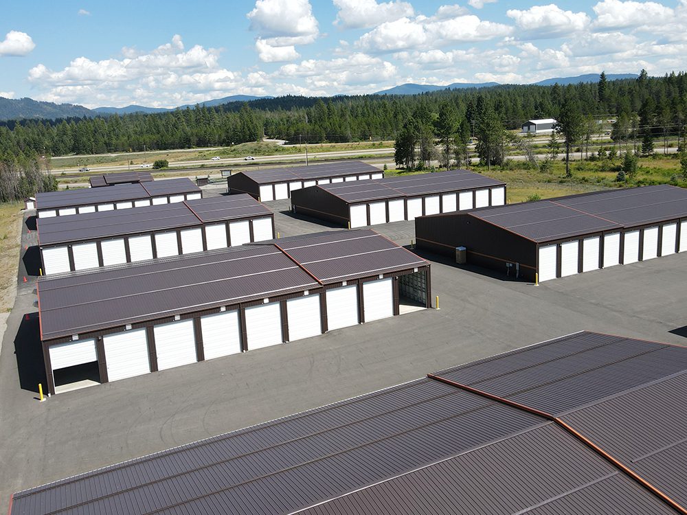 aerial view of a brown storage facility with white overhead doors