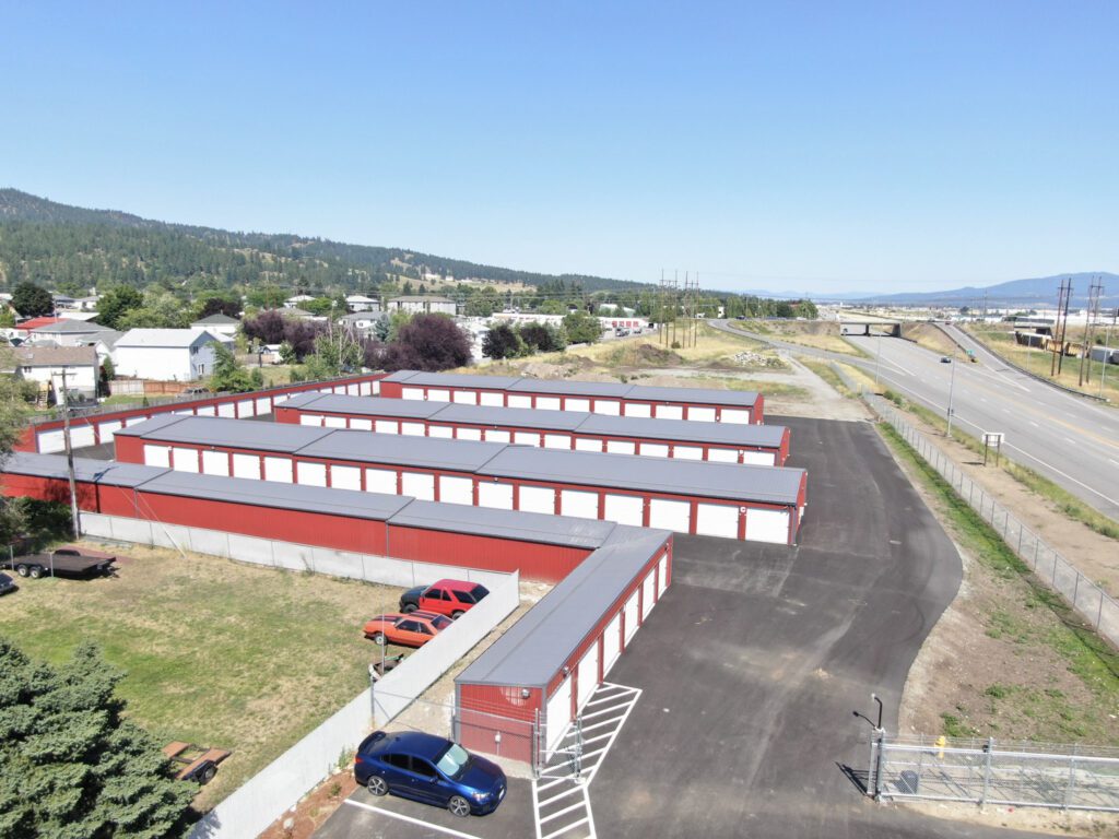 aerial view of a storage facility in Spokane, WA: red siding, grey roof, and white overhead doors