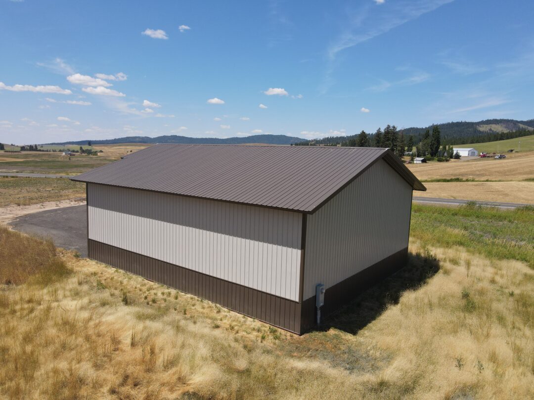 Steel structure shop with beige siding and brown metal roof