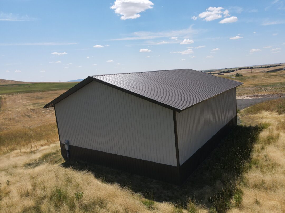 aerial view of a steel structure shop done in beige siding with brown roof