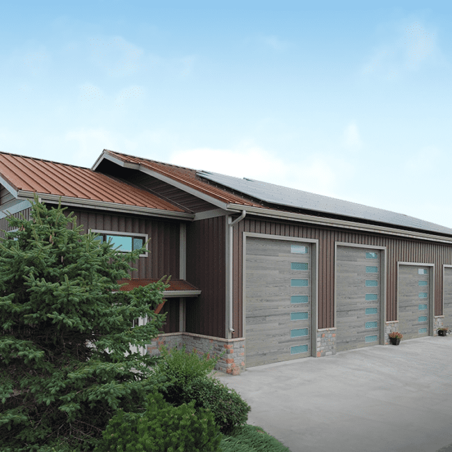 modern brown steel structure building with 4 garage doors and solar panels