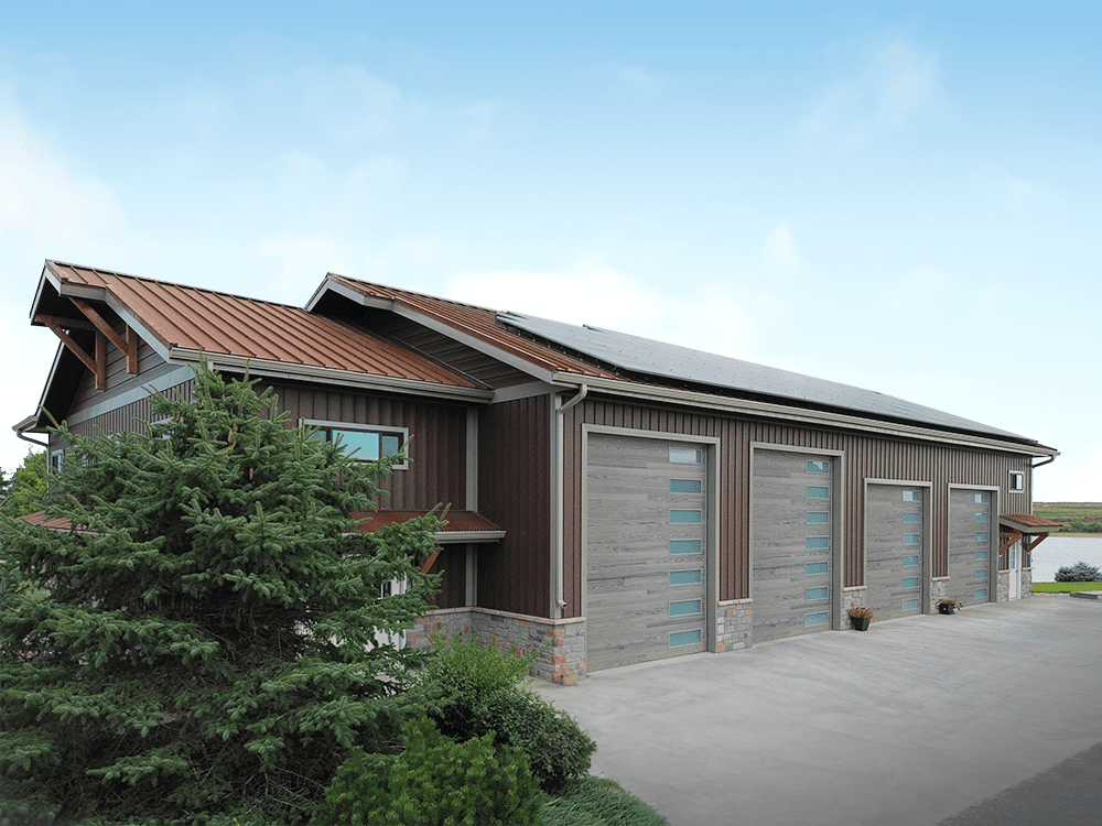modern brown steel structure building with 4 garage doors and solar panels