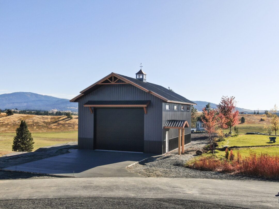 stylish charcoal gray building with copper styled steel roof in the fall landscape