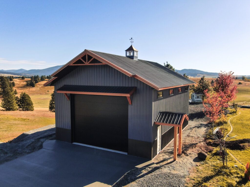stylish charcoal gray building with copper styled steel roof in the fall landscape