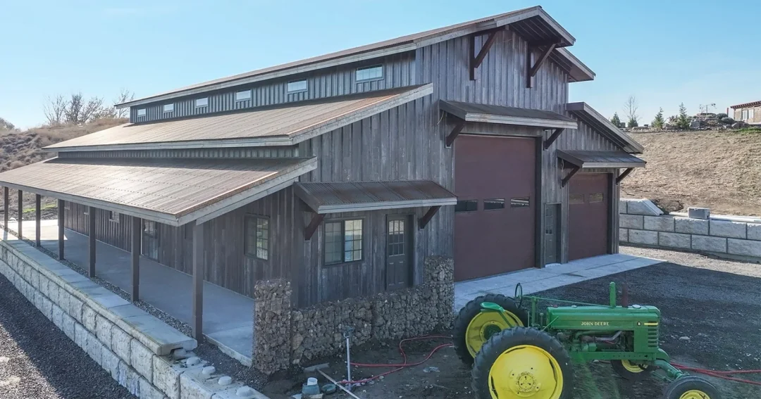 A pole barn with wood look metal siding and pot frame construction