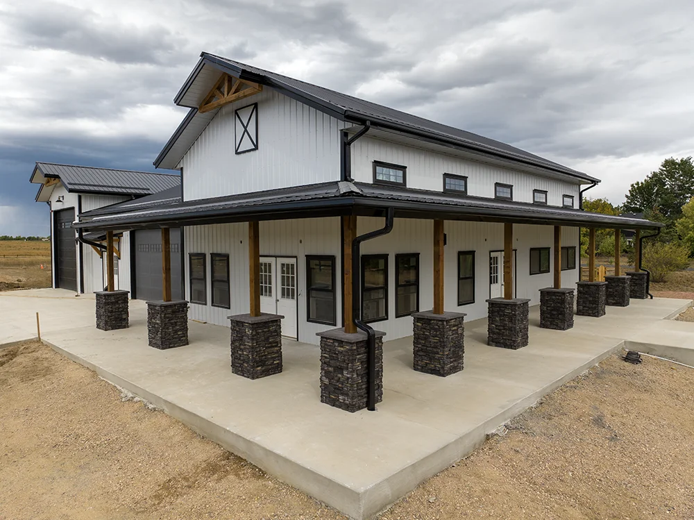 A corner shot of a custom white barndominium