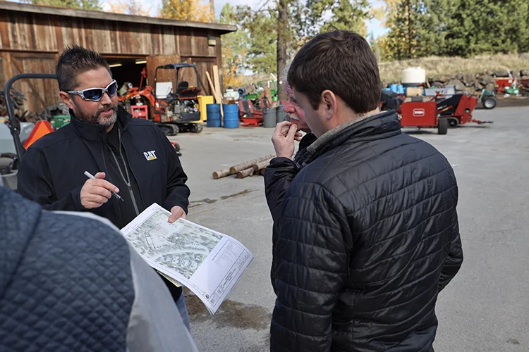 The Post frame construction superintendent explains the job plan to the client