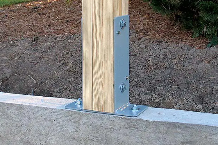 A strudiwall post support in installed on top of a pole barn foundation