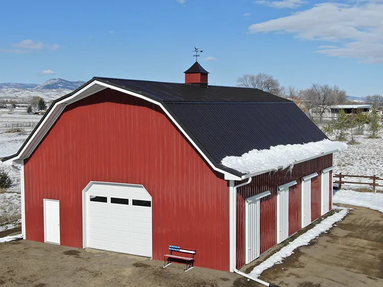 A red and white enclosed hay barn