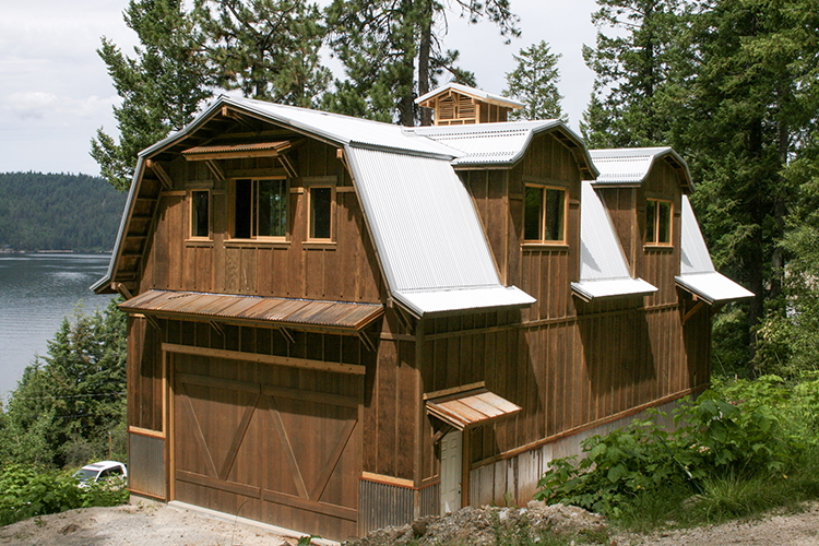 A gambrel pole parn on lake coeur d'Alene, featuring wood look steel siding, build by Steel Structures America