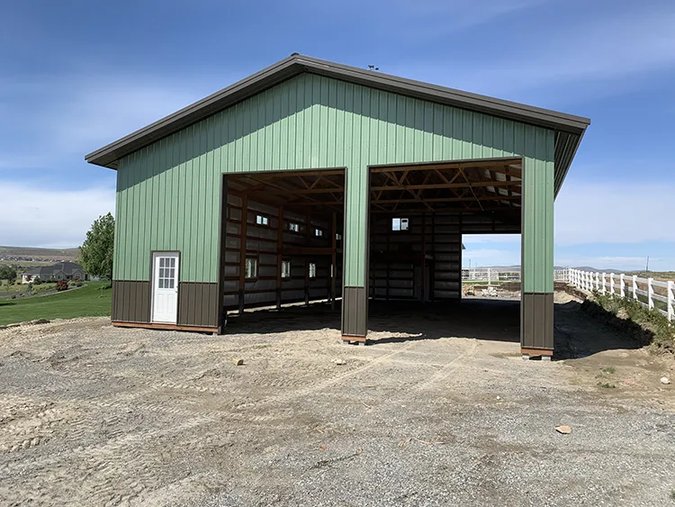 A green hay barn building