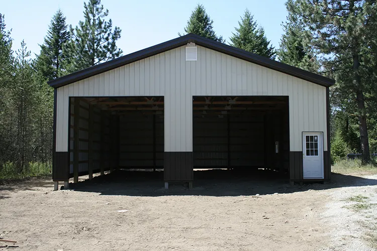A white hay barn with ventilation on the bottom