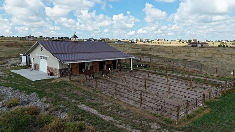Some custom horse stables with an outdoor pen