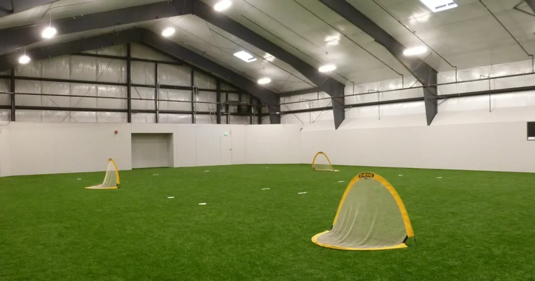 An indoor sports area in a pole barn. A soccer field is set up