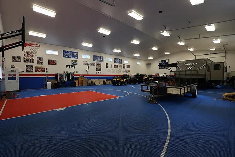 An indoor basketball court inside a post-frame pole barn