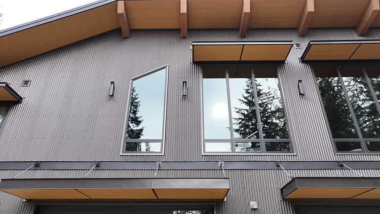 A post frame building's windows. The building is brown