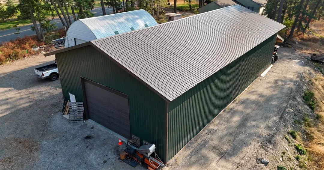 A quonset hut and pole building sit side by side