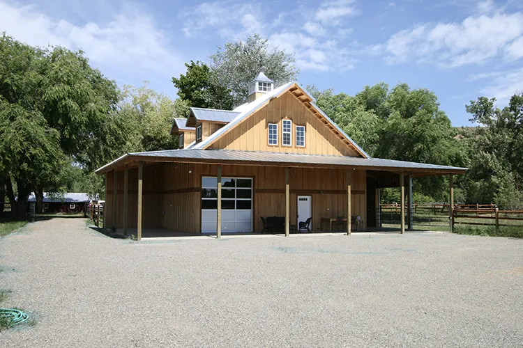A small pole building home, tan in color