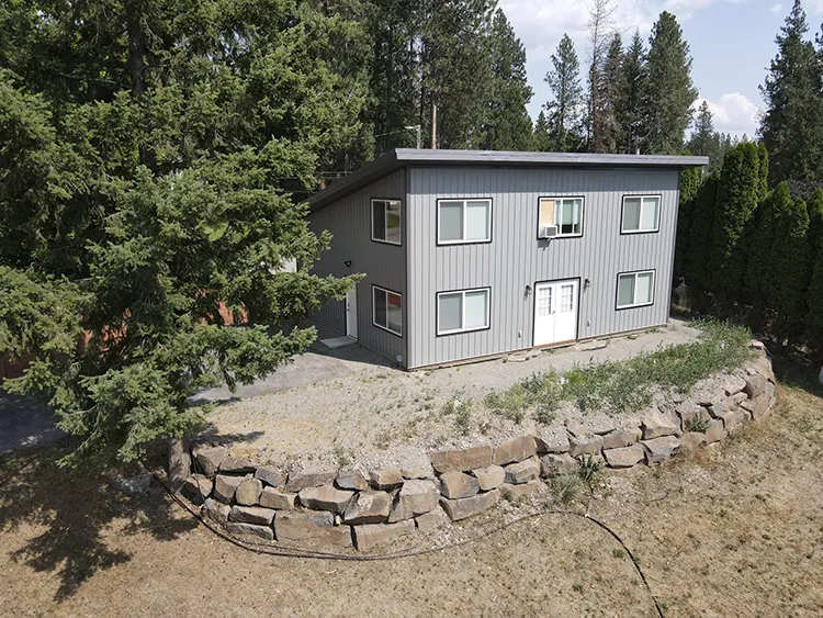 A small two story compact grey barndominium