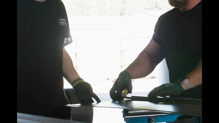 Employees at steel structures America measuring some steel siding