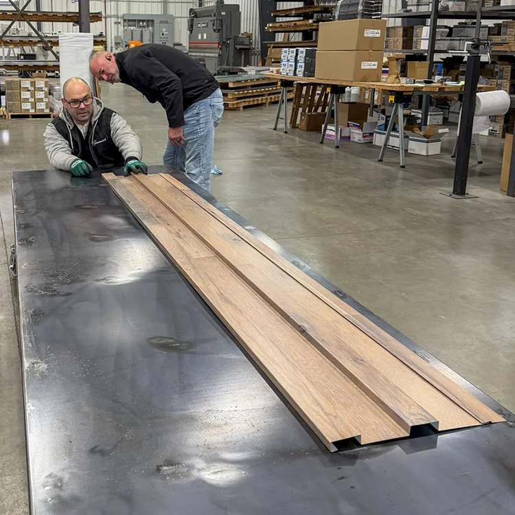 Metal america employees check a steel panel for imperfections