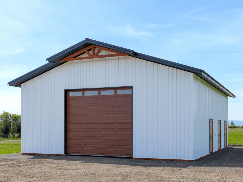 A beautiful white and brown pole barn that would definitely increase a property's value