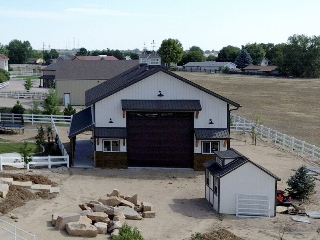 Pole barn wainscoting adds a contrasting band around the base of this two-tone building